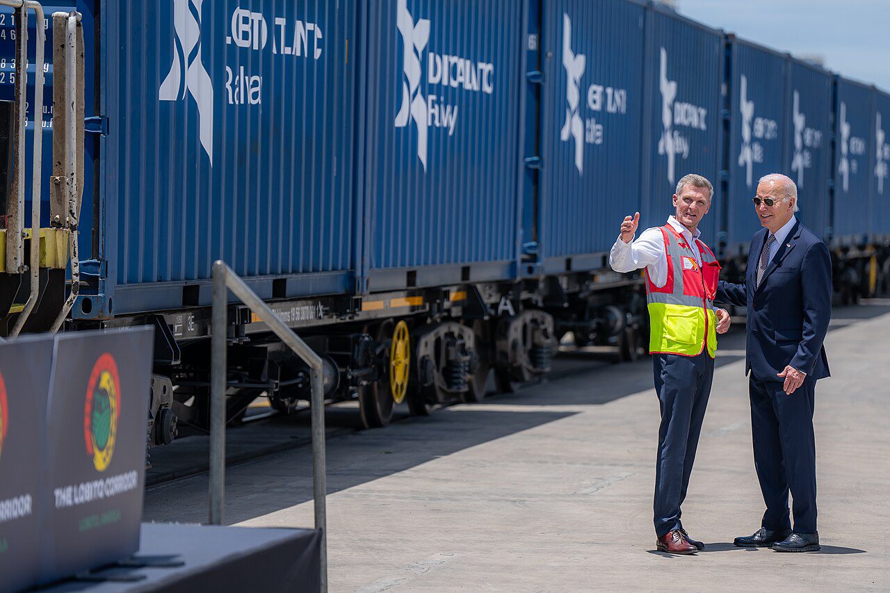 Then US President Joe Biden with Lobito Atlantic Railway COO Nicolas Gregoire beside freight containers at Lobito Port Terminal on 4 December 2024; not the 2026 contractor selection.